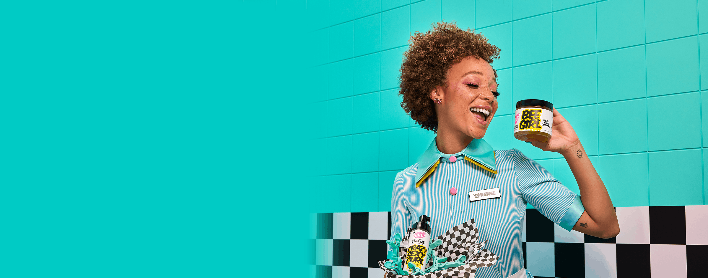 Woman holding a product container against a turquoise tiled wall